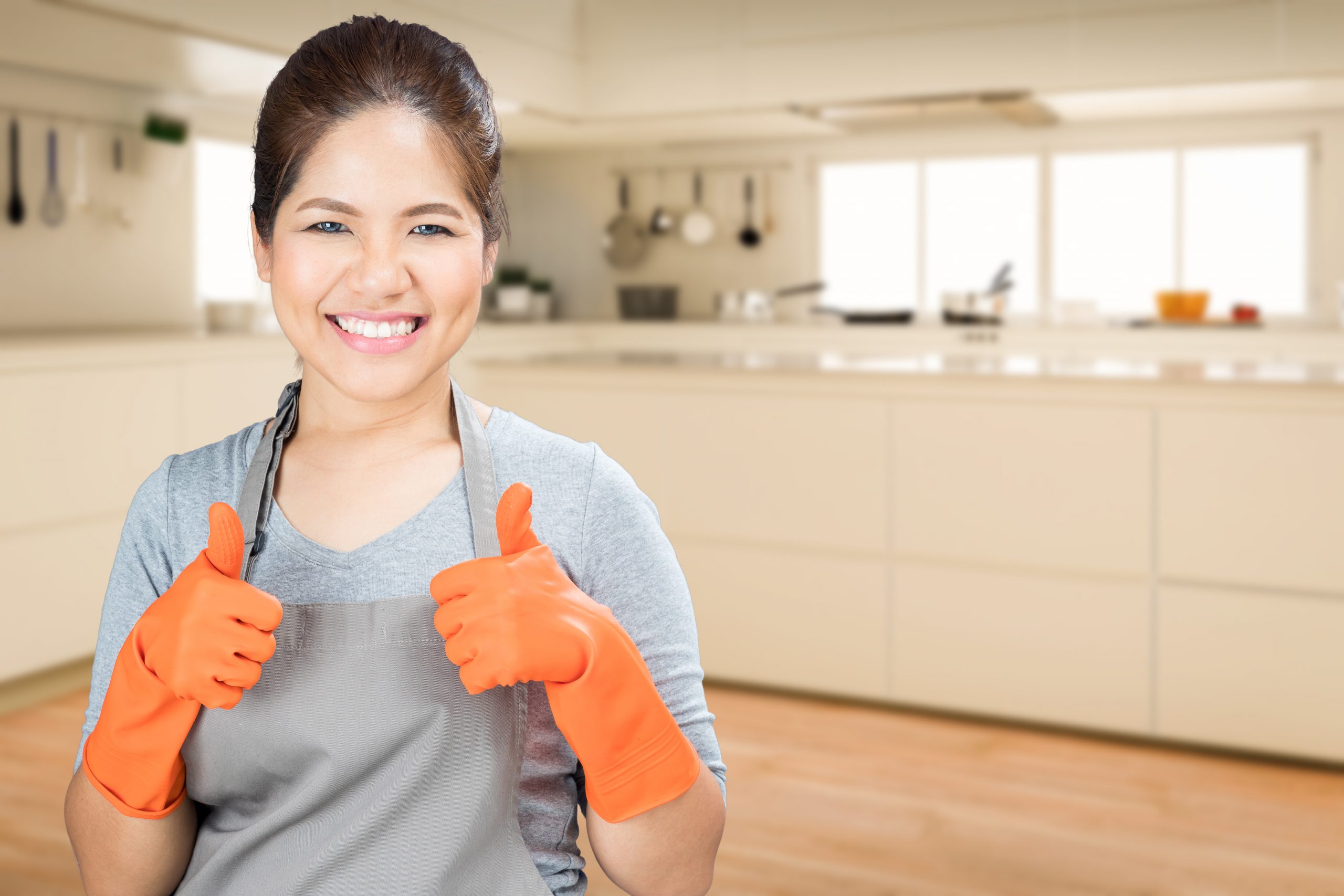 asian housewife wearing rubber gloves thumbs up